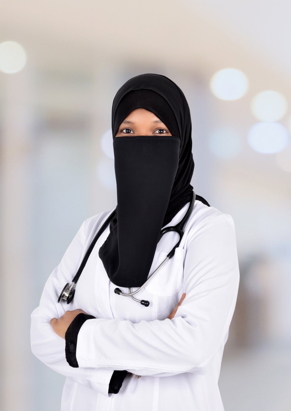 Dr Farida Fanda, GP Doctor, in a white coat with a stethoscope